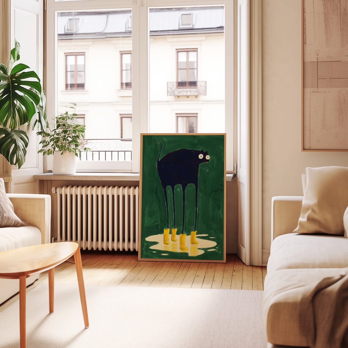 Green rainy day cat print in an oak frame leaning below tall French windows