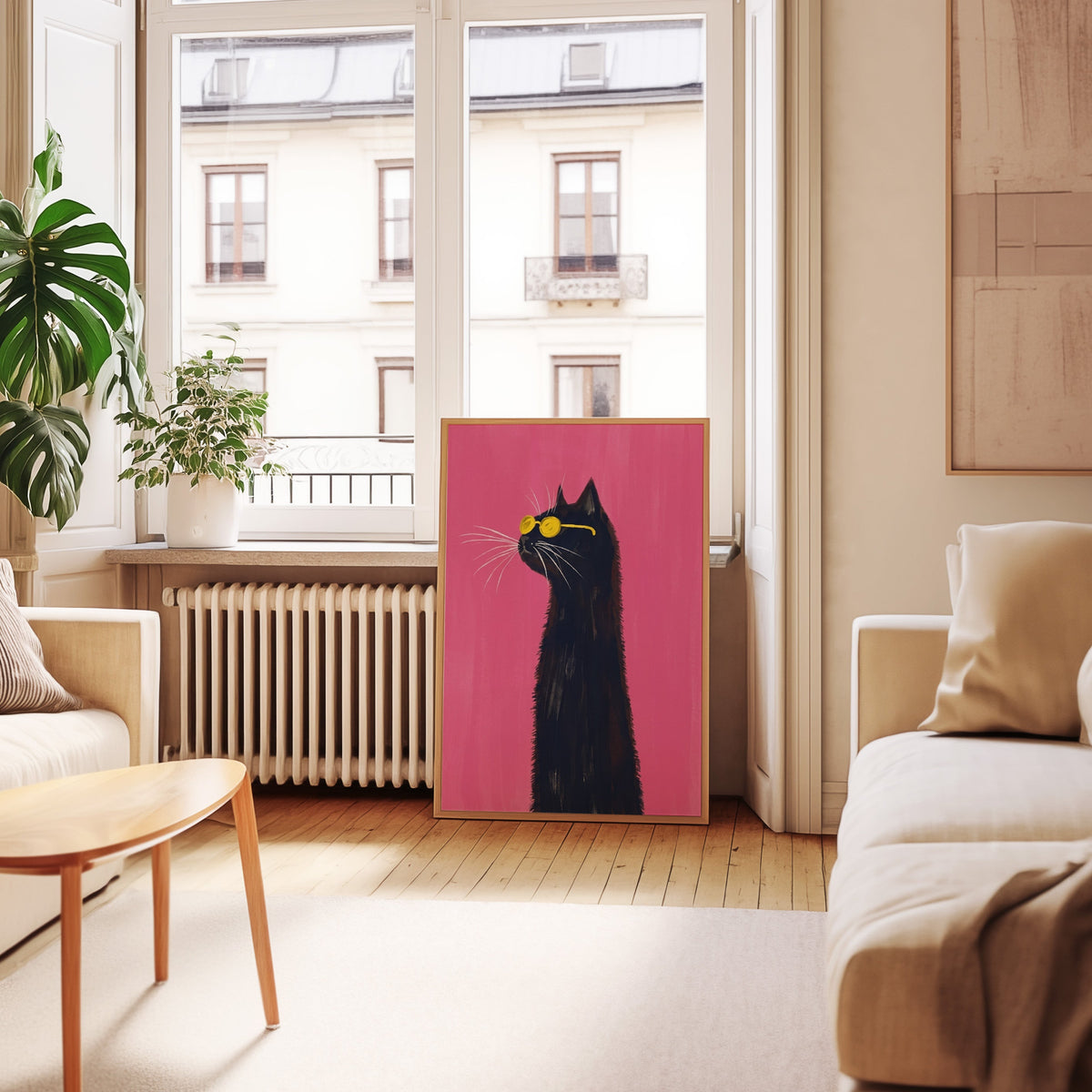 Black cat sunglasses print in an oak frame leaning below tall French windows