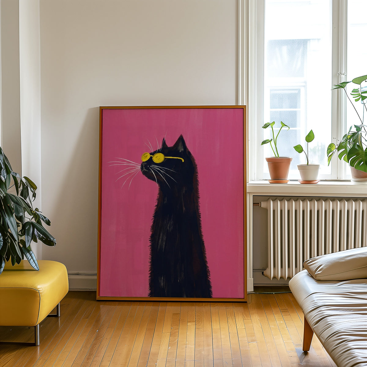 Long-necked black cat print in an oak frame leaning beside a yellow leather bench