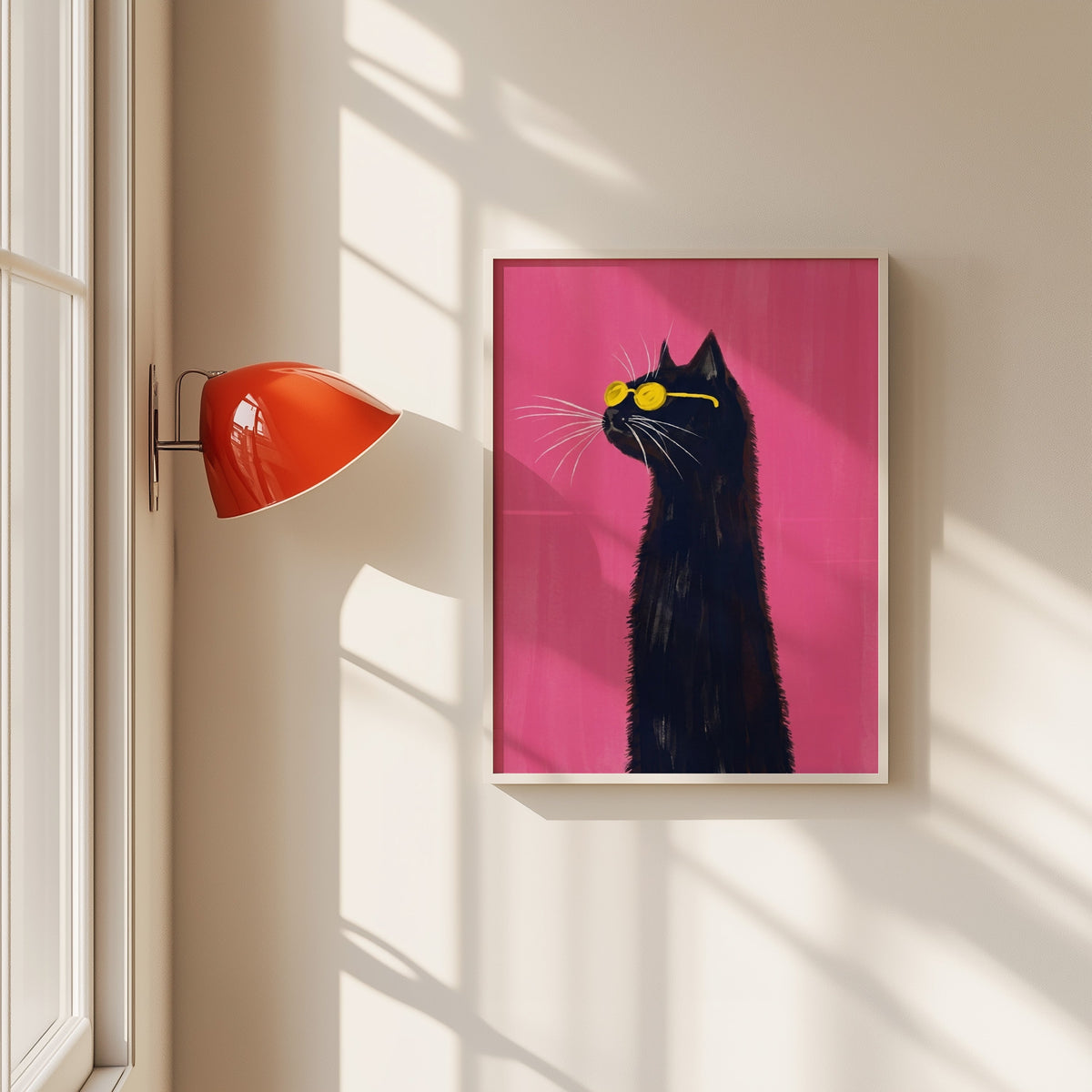 Black cat in yellow sunglasses print in a white frame beside a red wall sconce