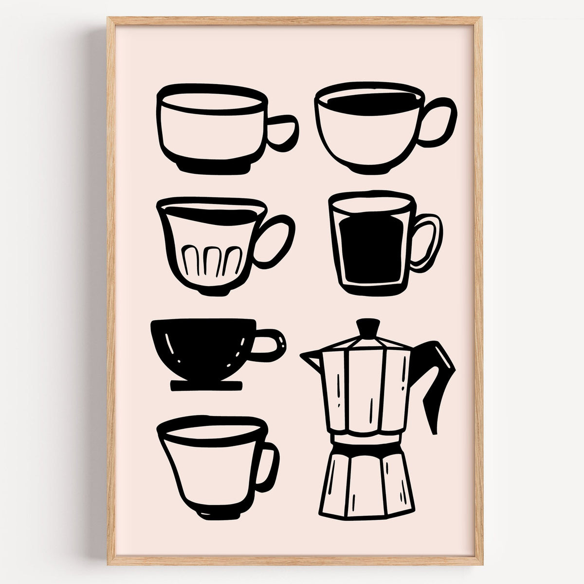 Black coffee cups and moka pot print in a light oak frame on a plain white wall