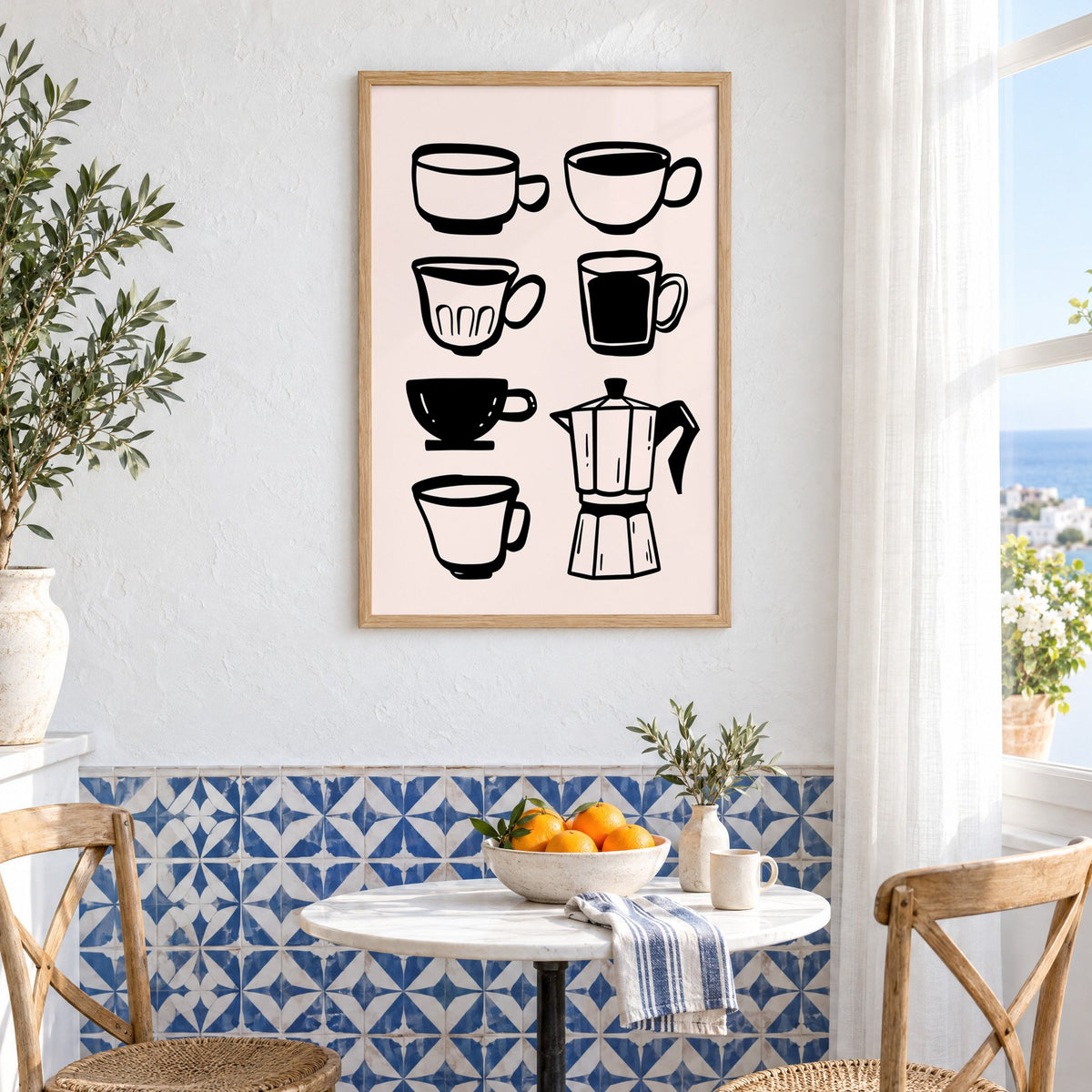 Black coffee cups and moka pot print in an oak frame above a bistro table and blue patterned tiles