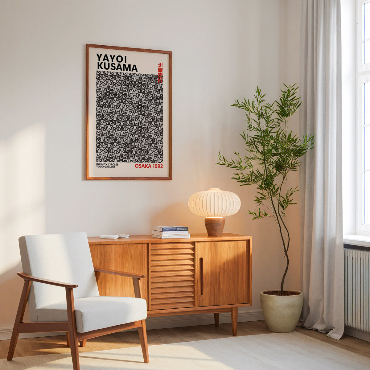 Yayoi Kusama inspired black concentric circles print above a wood sideboard beside an armchair and tall plant