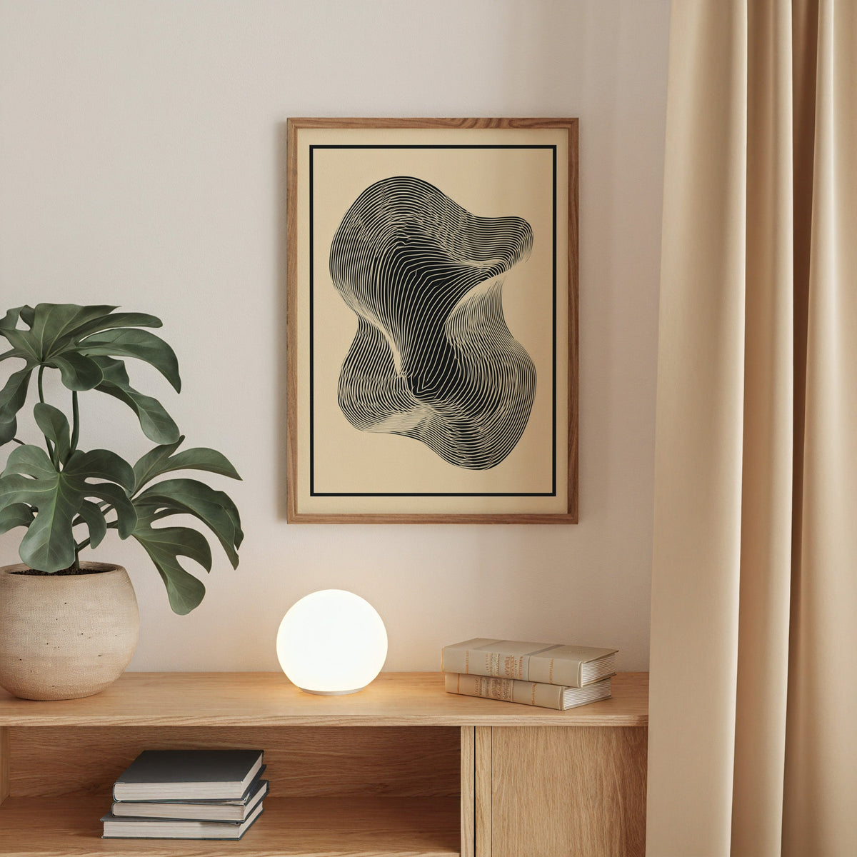 Black contour line blob minimalist op art print in a walnut frame above an oak cabinet with a glowing globe lamp