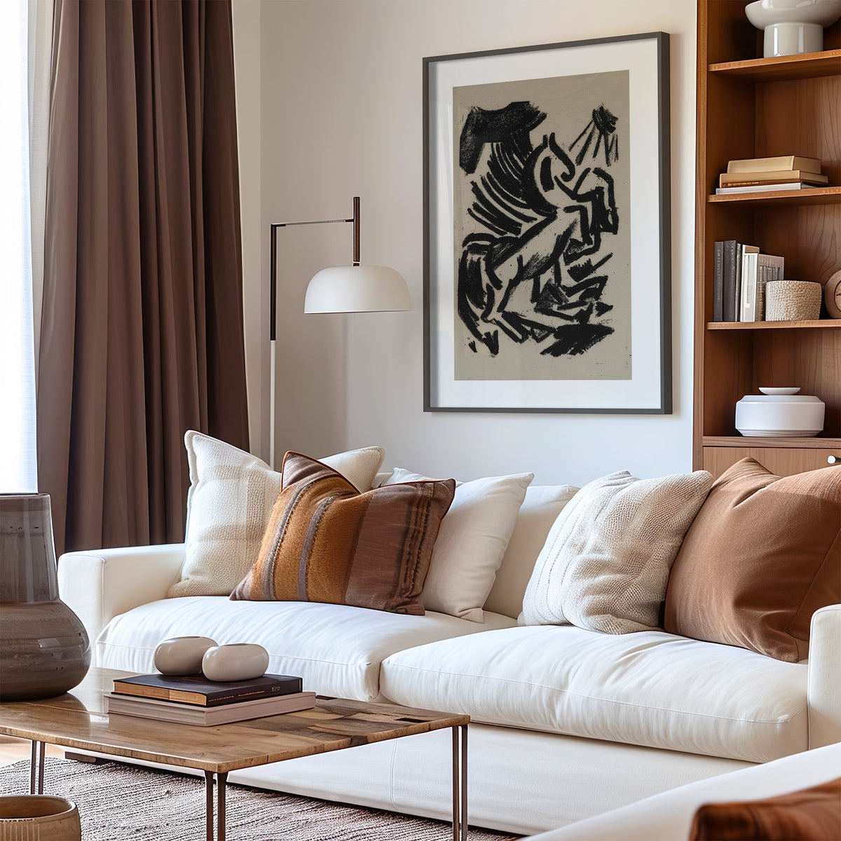 Black crayon rearing animal and sun print in a black frame above a cream sofa with brown striped pillows