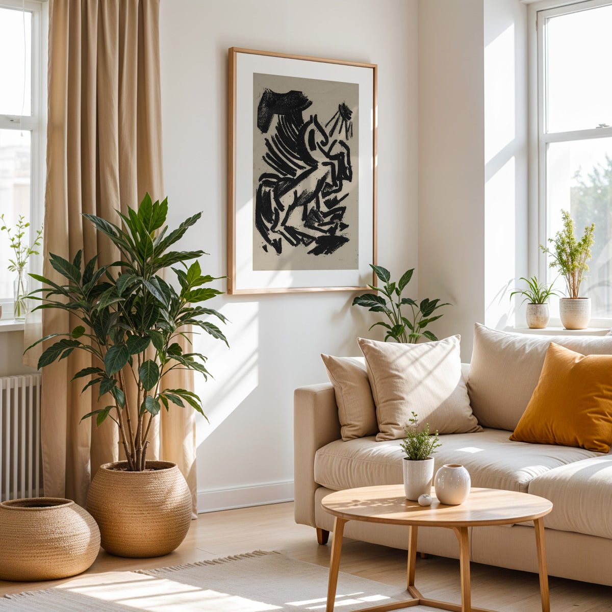 Black crayon rearing animal and sun print in an oak frame above a cream sofa beside a tall plant in a woven pot