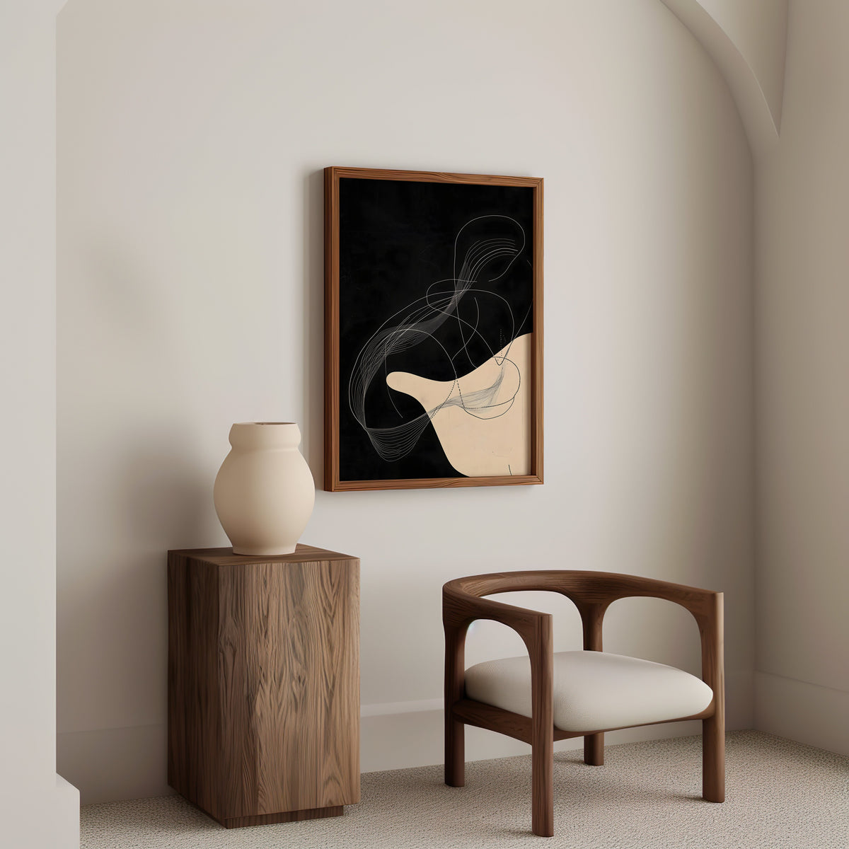 Black and cream flowing line art abstract print in a walnut frame above a wood pedestal and a curved walnut armchair