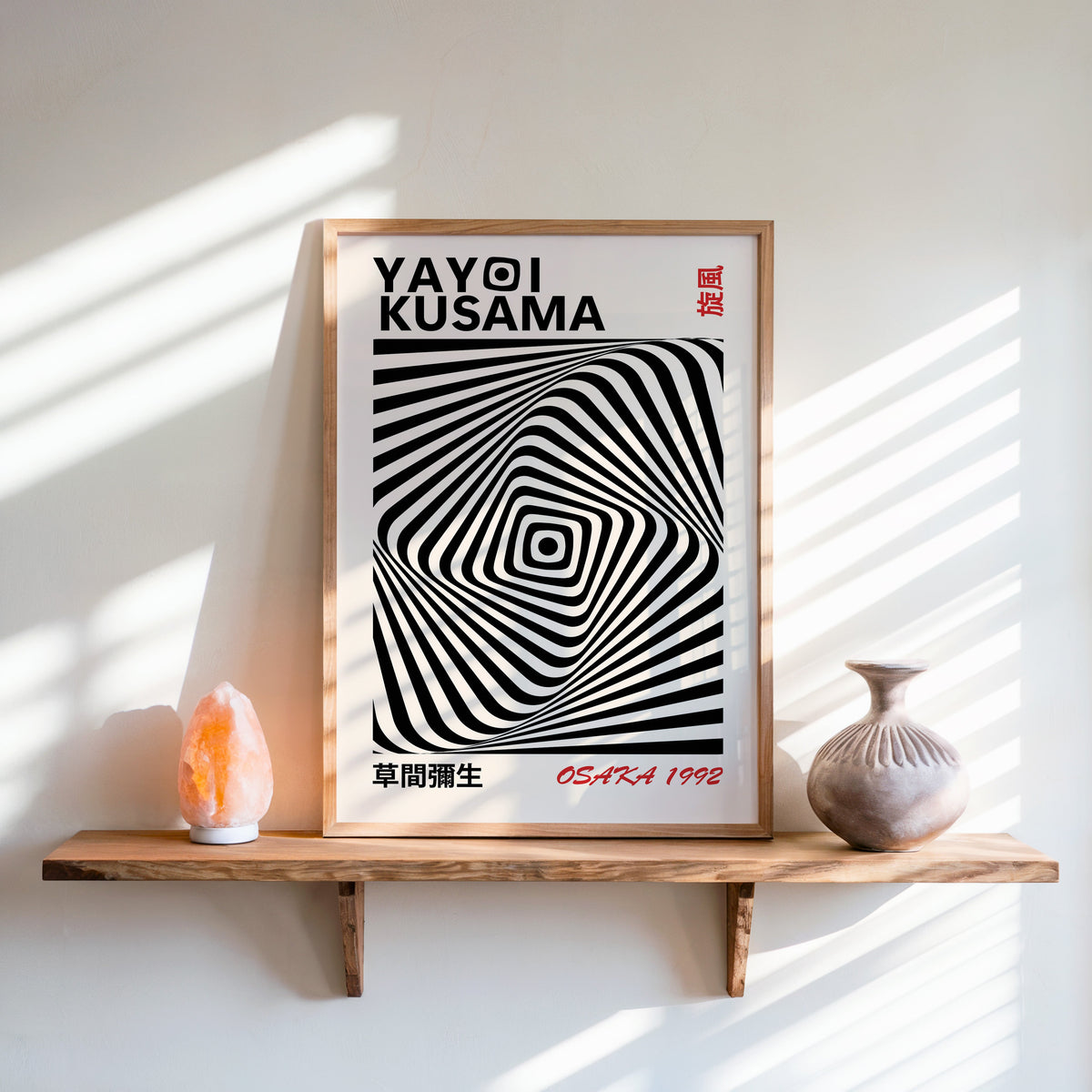 Yayoi Kusama inspired black diamond warp op art print in an oak frame on a live edge shelf beside a salt lamp