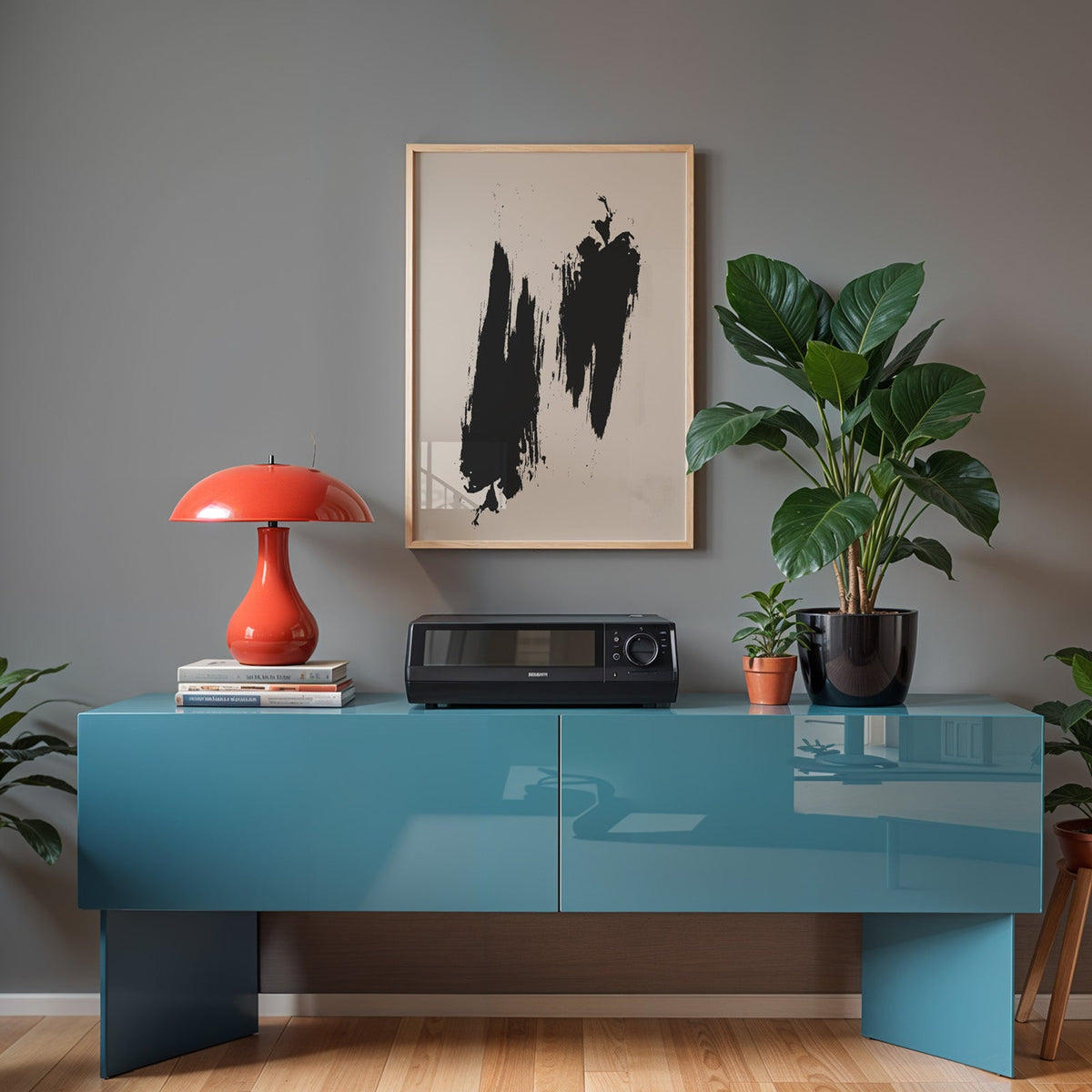 Black dry brush twin strokes minimalist print in a light oak frame above a teal sideboard with a red mushroom lamp