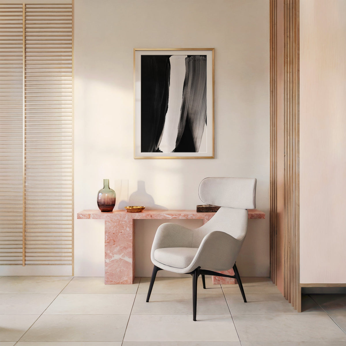 Black white and gray vertical brush sweeps print shown in a gold frame with a mat above a pink marble console and armchair