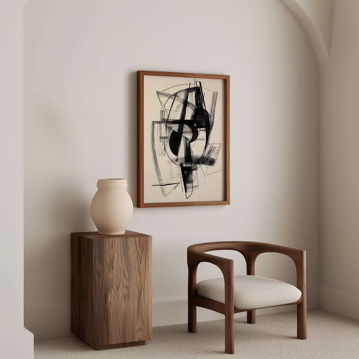 Black ink abstract sketch line art print in a walnut frame above a wood pedestal and a curved walnut armchair