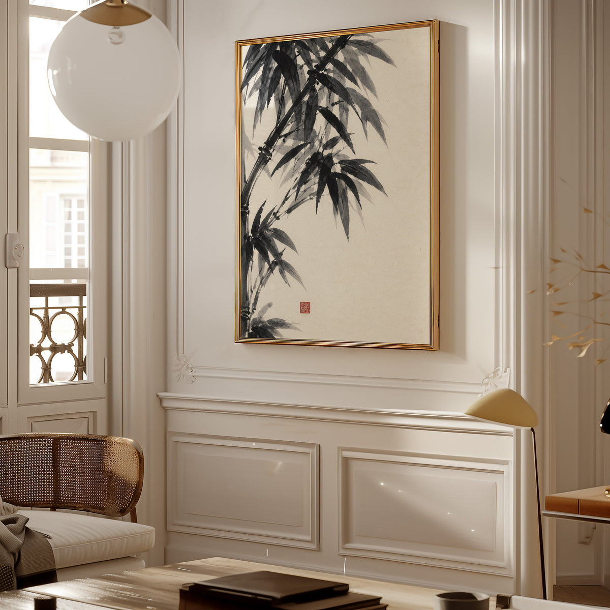 Black ink bamboo sumi-e poster shown in a gold frame on a paneled wall in a Parisian-style living room