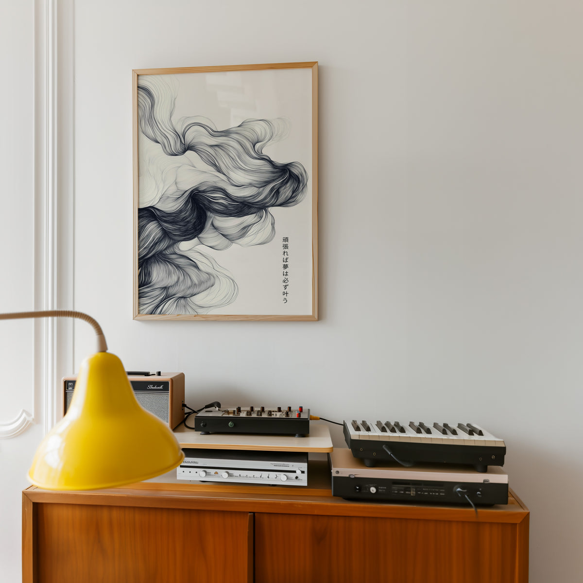 Black ink swirl dreams proverb print in an oak frame above a teak sideboard with vintage hi-fi