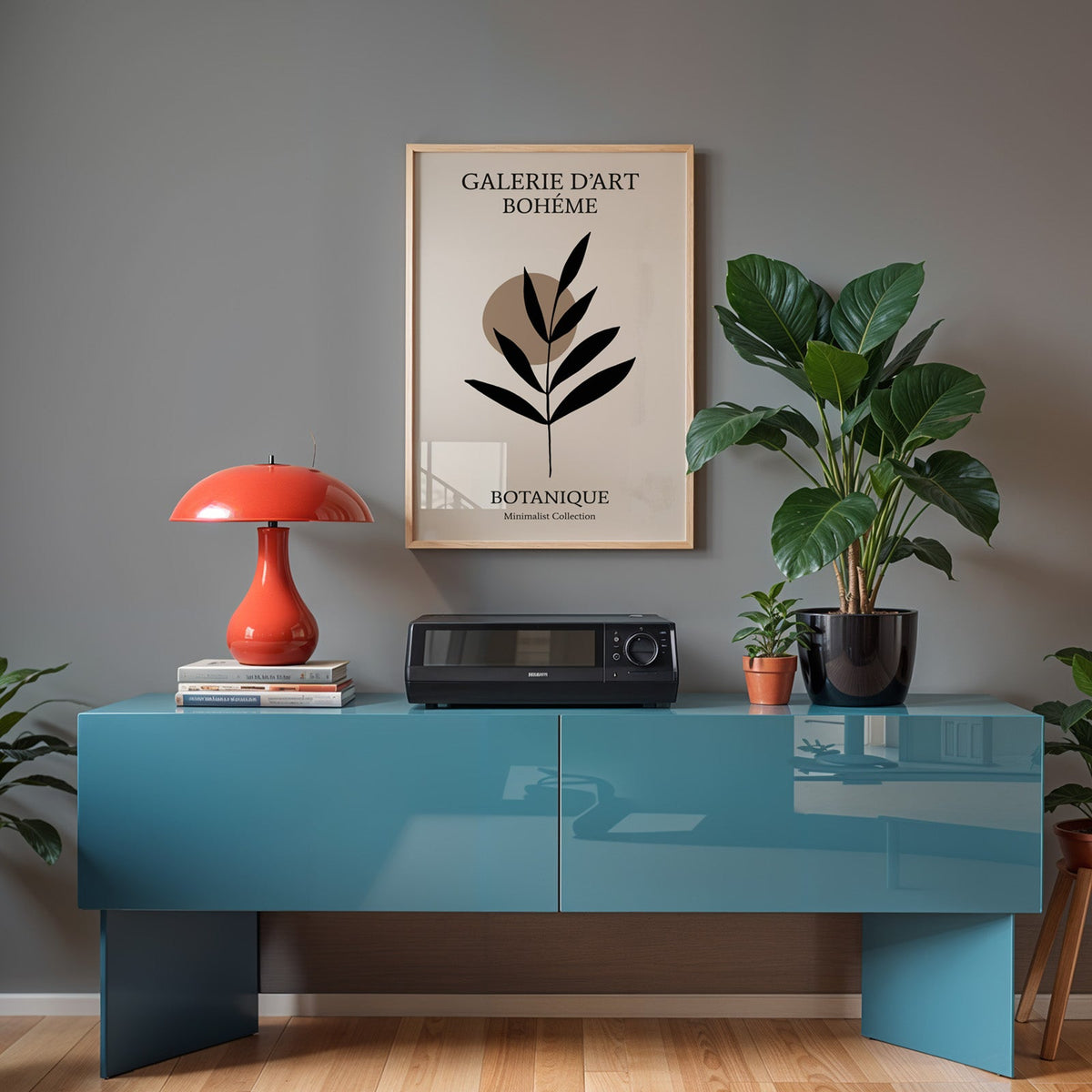Black leaf sprig and taupe circle boho print in a light oak frame above a teal sideboard with a red mushroom lamp