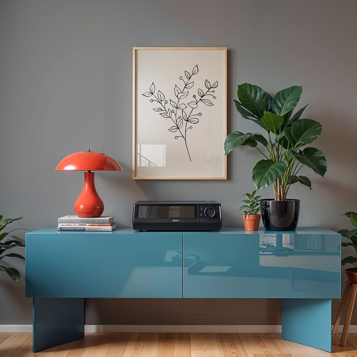 Black line berry sprig minimalist print in a light oak frame above a teal sideboard with a red mushroom lamp
