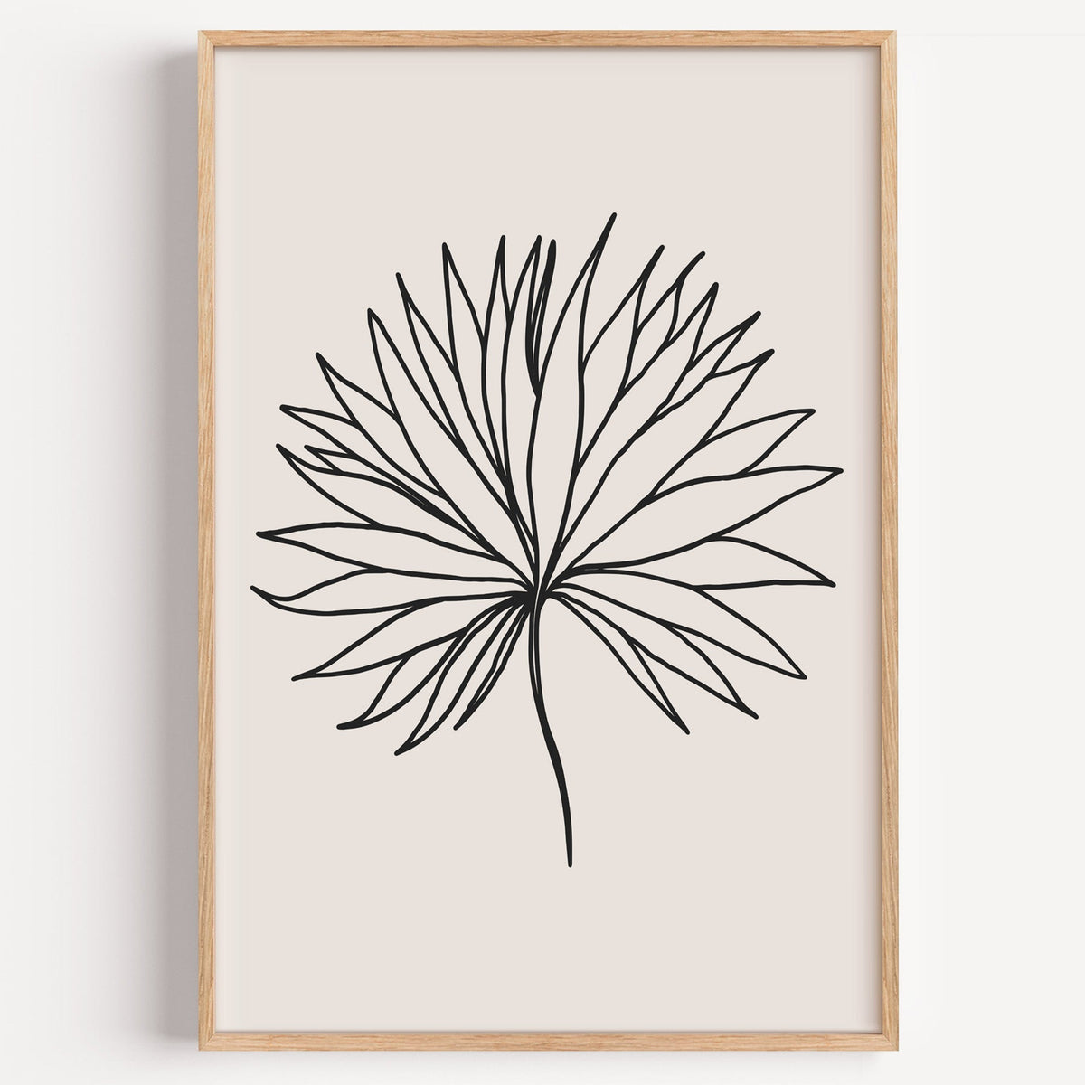 Black line fan leaf minimalist print in a light oak frame on a plain white wall