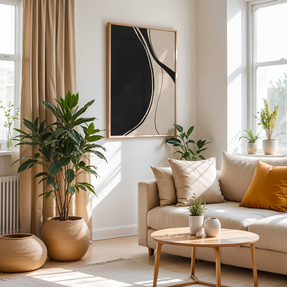 Black organic shape and flowing lines minimalist print in an oak frame above a cream sofa beside a tall plant in a woven pot