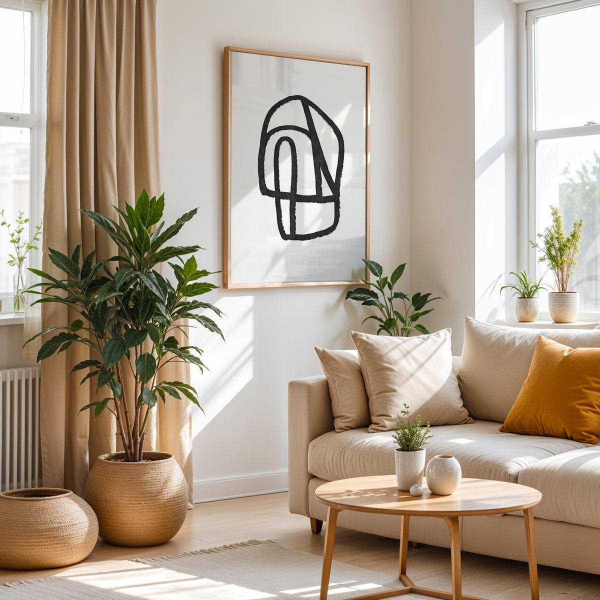 Black outline segmented pebble shape print in an oak frame above a cream sofa beside a tall plant in a woven pot