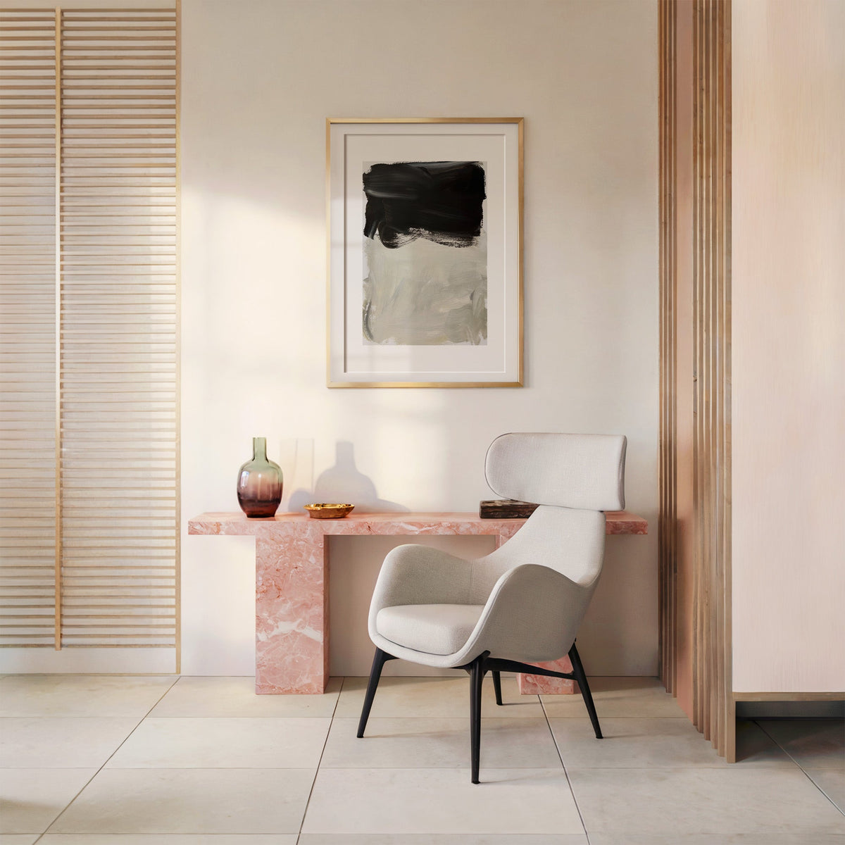 Black over greige brush block print shown in a gold frame with a mat above a pink marble console and armchair