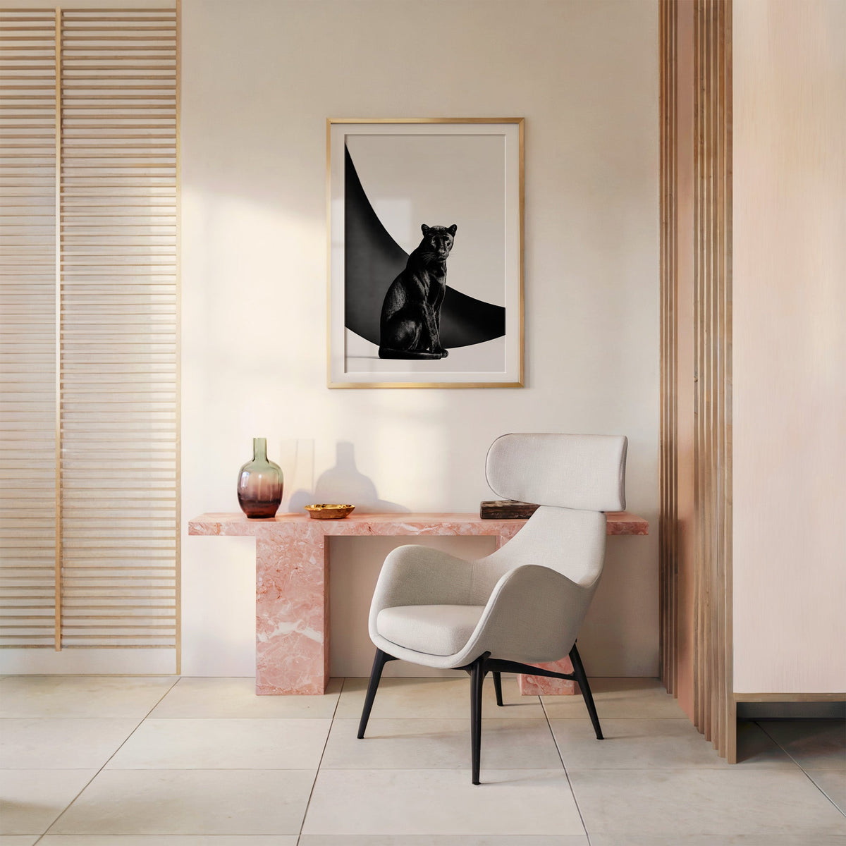 Seated black panther in front of black arc print shown in a gold frame above a pink marble console and armchair