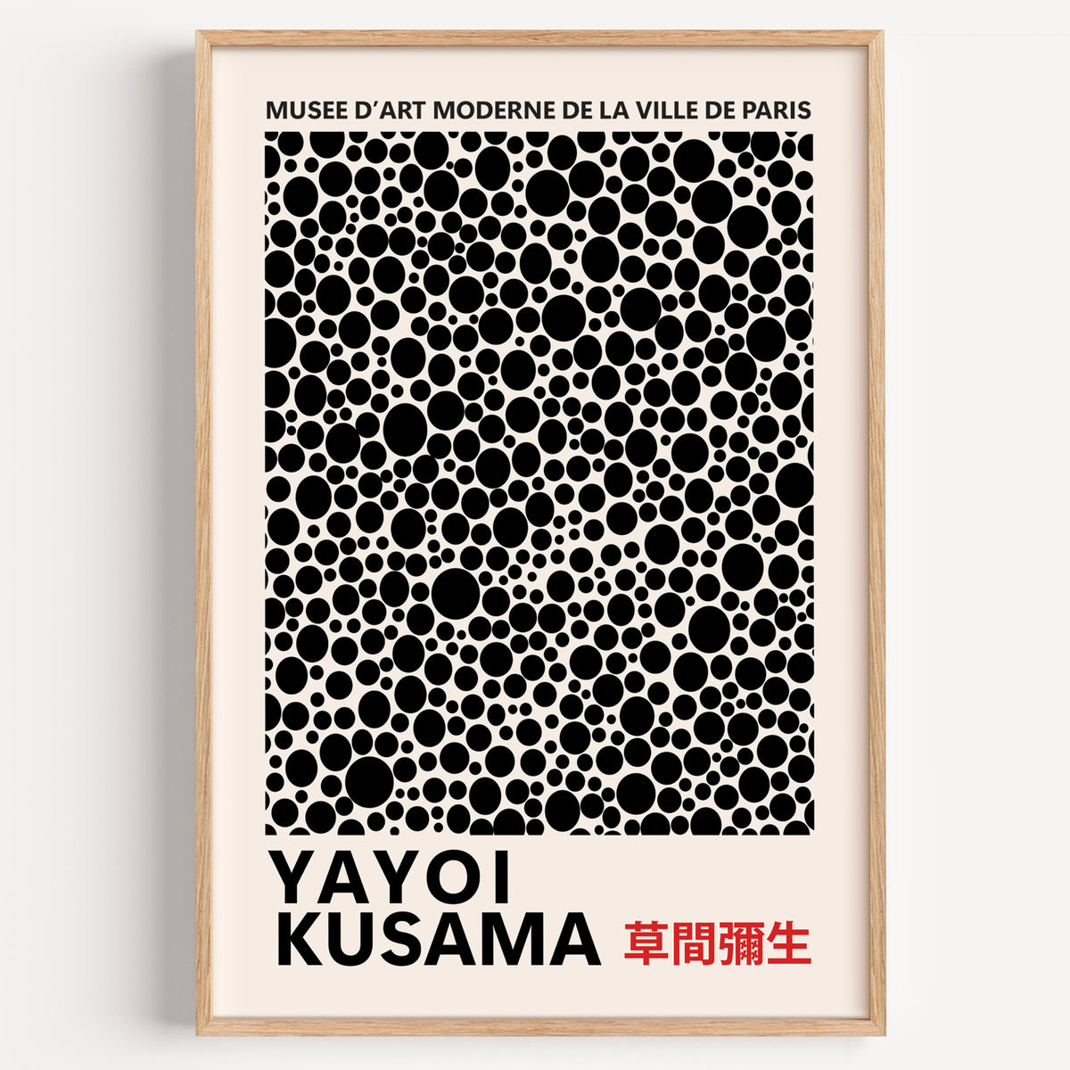 Yayoi Kusama inspired black polka dot pattern print in a wood frame on a plain wall
