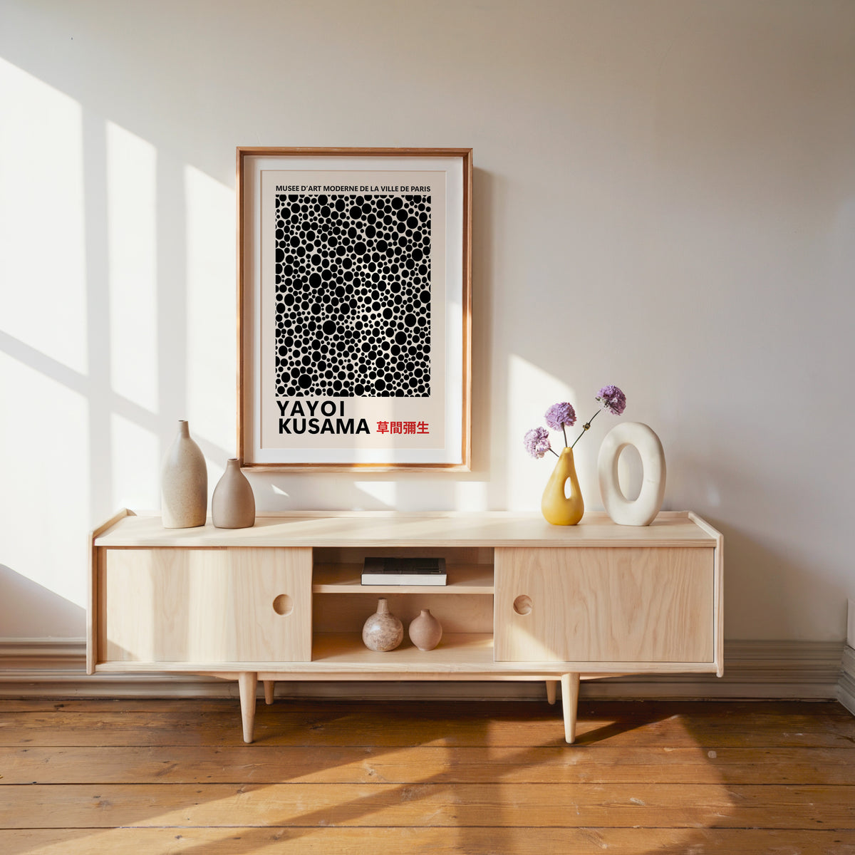 Yayoi Kusama inspired black polka dot pattern print above a pale wood console
