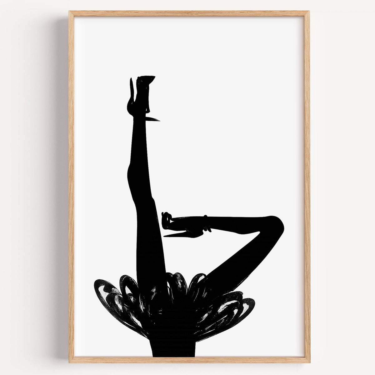 Black silhouette legs in heels with brushstroke skirt print in a light oak frame on a plain white wall