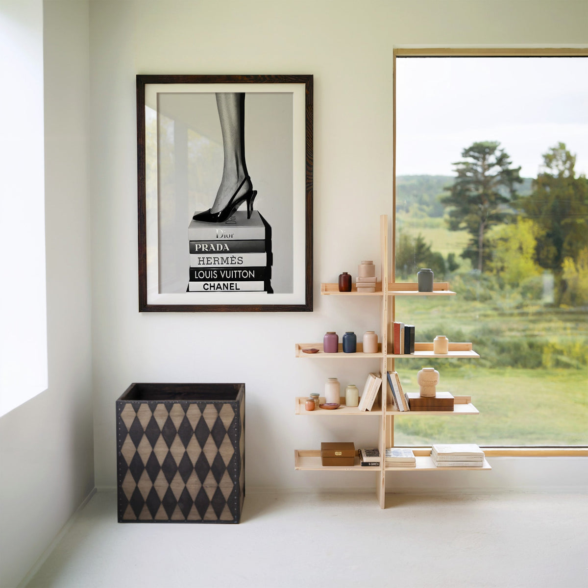 Glossy slingback heel standing on stacked books print in a walnut frame with a white mat beside wooden shelves and a garden window