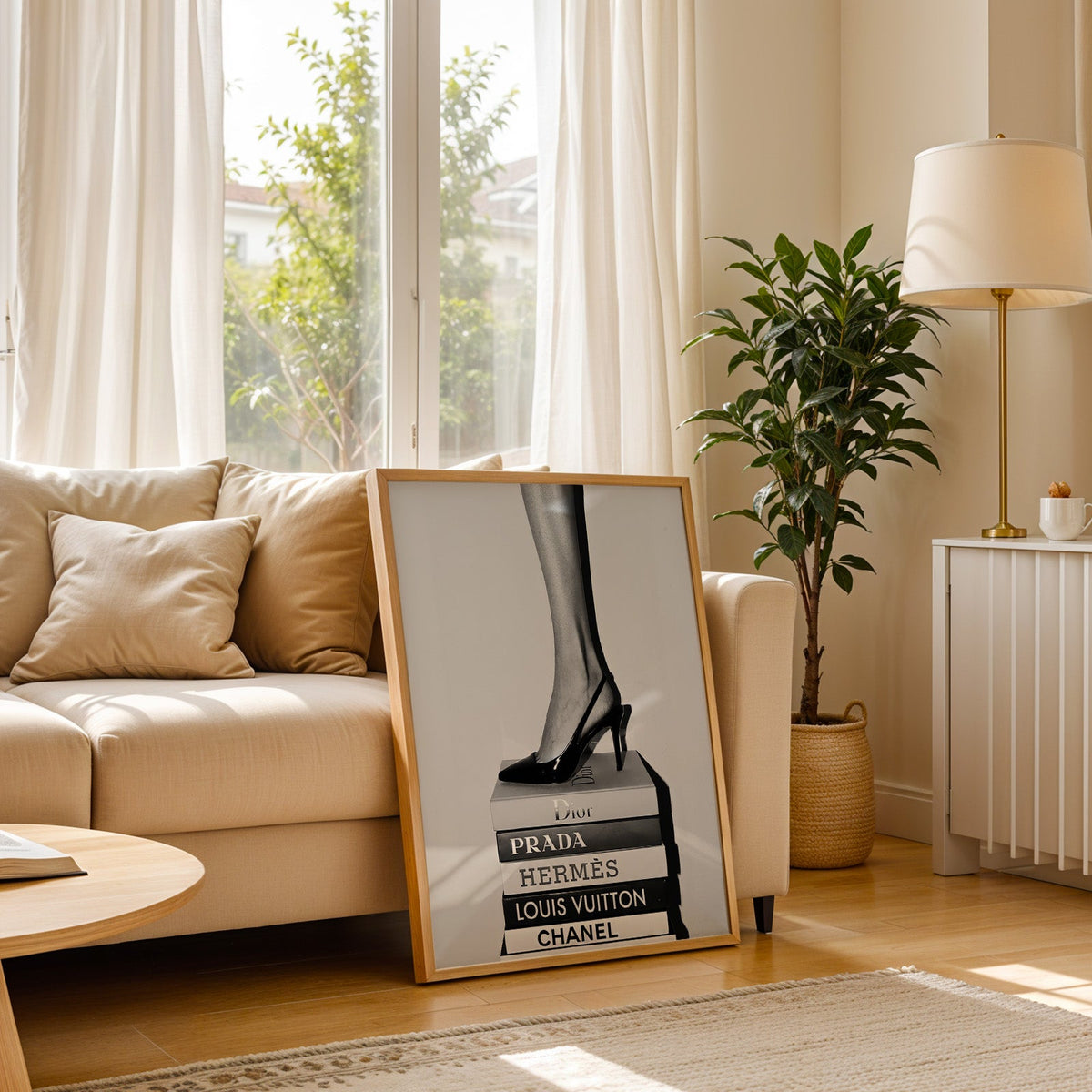 Glossy slingback heel standing on stacked books print in a light oak frame leaning on a cream sofa beside a floor lamp