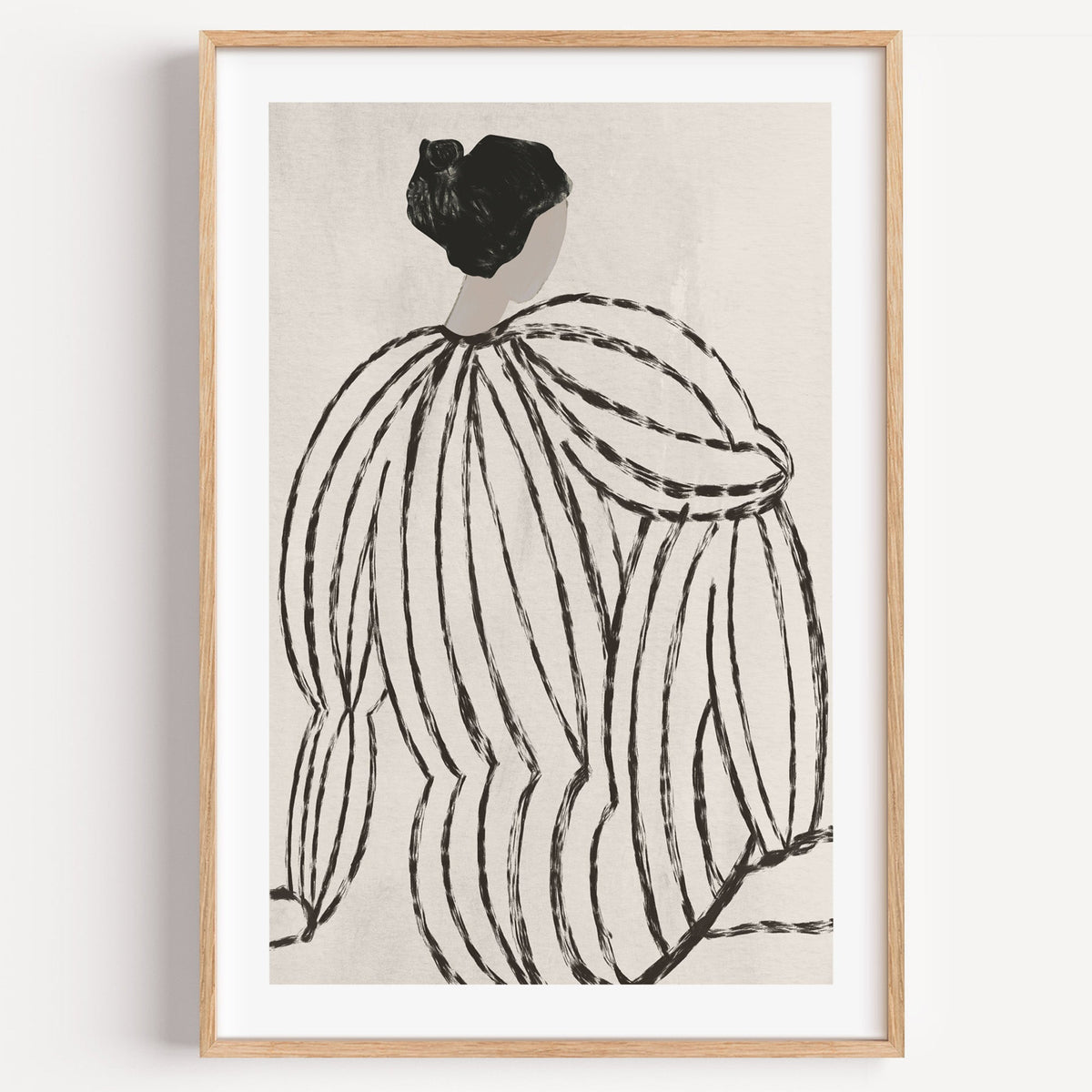 Woman in striped blouse from behind sketch print in a light oak frame on a plain white wall