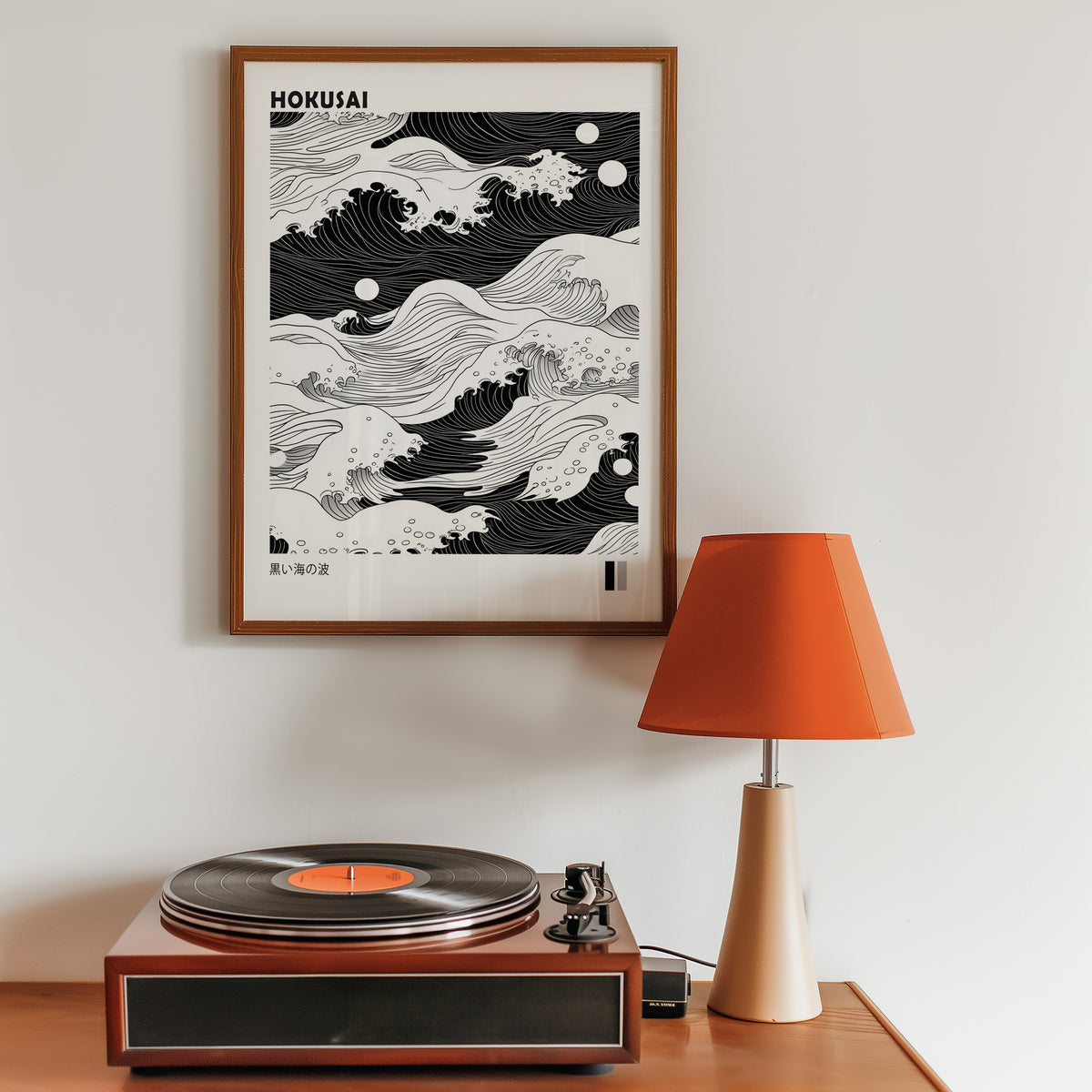 Black sea waves with twin moons print in a walnut frame above a sideboard with a record player