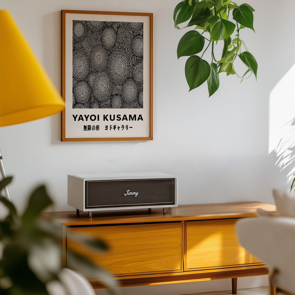 Yayoi Kusama inspired black and white oval net print above a sideboard with a plant