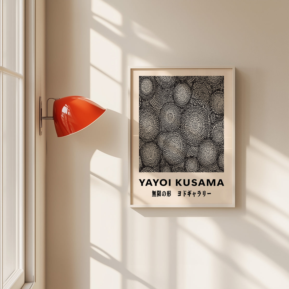 Yayoi Kusama inspired black and white oval net print in a white frame by a red wall lamp