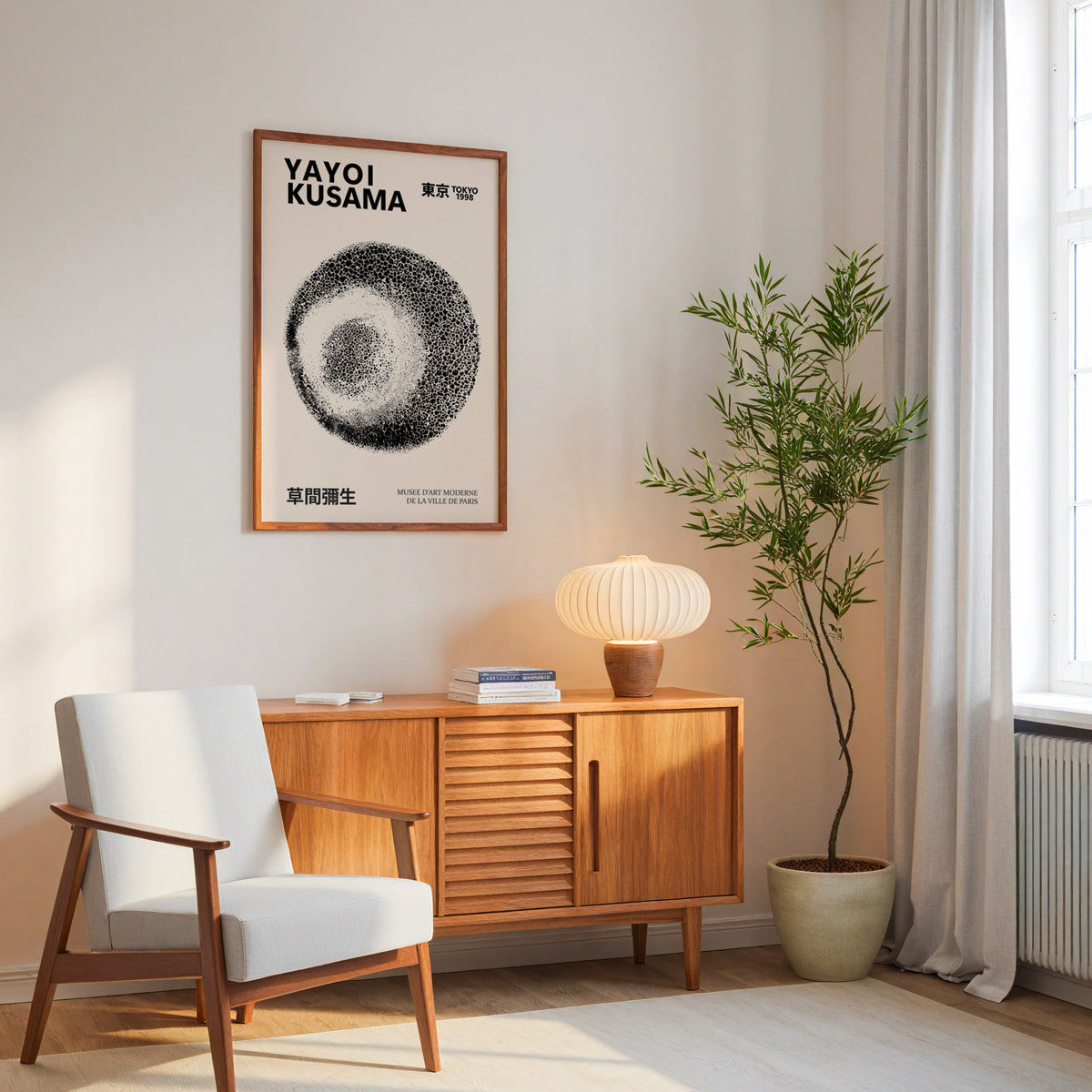 Yayoi Kusama inspired black and white stippled orb print above a mid-century sideboard
