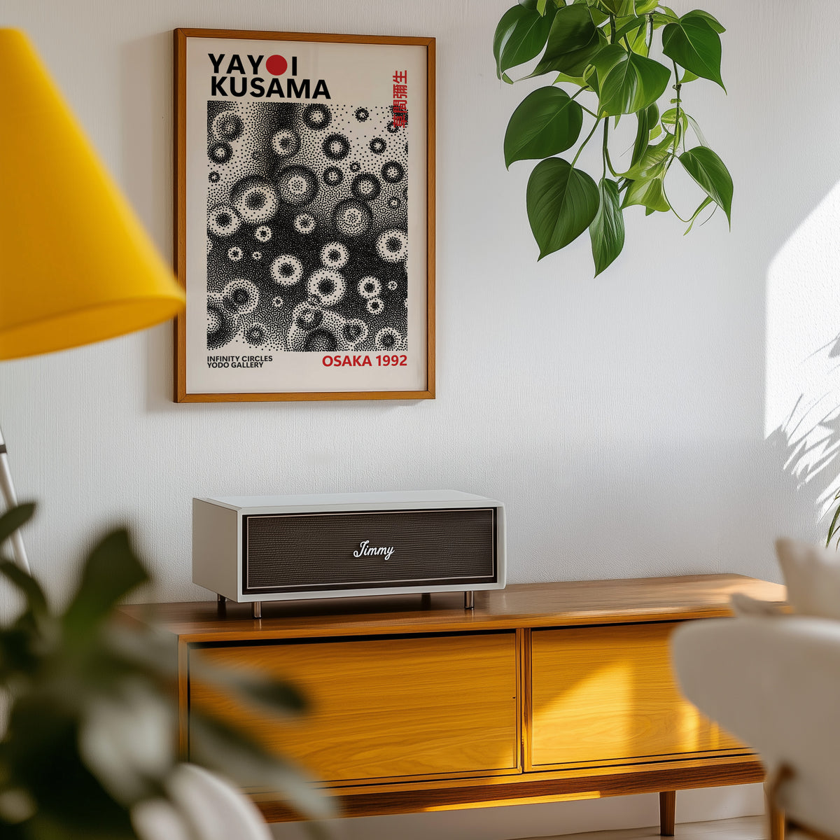 Yayoi Kusama inspired black and white stippled ring print above a sideboard with a plant