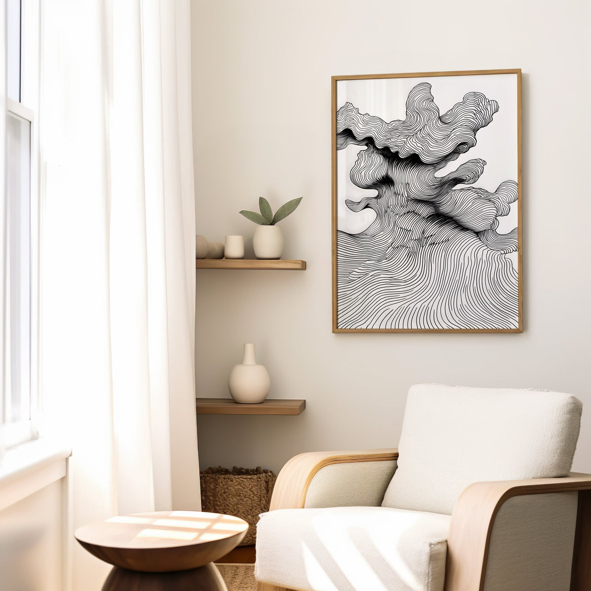 Black and white topographic wave line art print in a slim oak frame above a cream boucle armchair by floating shelves