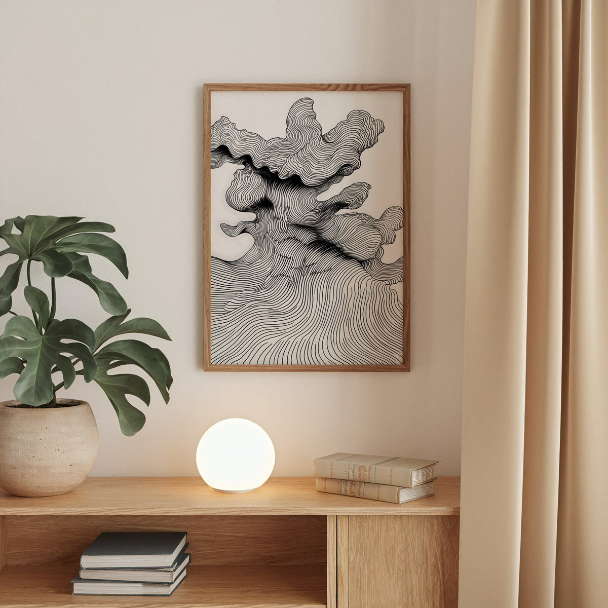 Black and white topographic wave line art print in a walnut frame above an oak cabinet with a glowing globe lamp