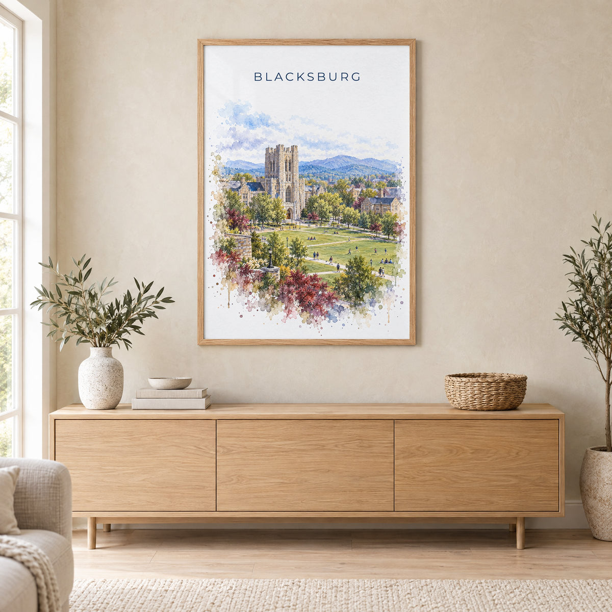 Blacksburg watercolor print in an oak frame above a light wood sideboard in a Scandinavian living room