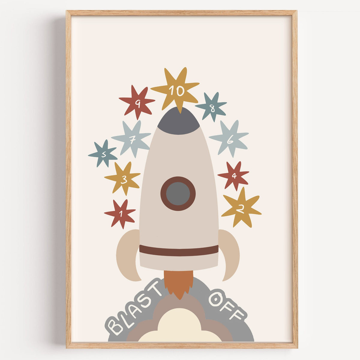 Blast off rocket countdown nursery print in a light oak frame on a plain white wall