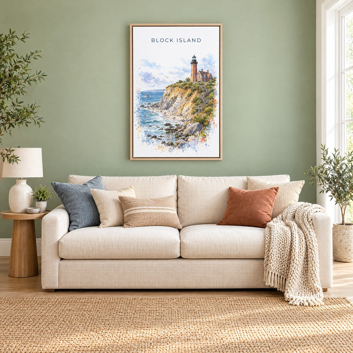 Block Island watercolor print as a natural floater canvas above a cream linen sofa on a sage green wall