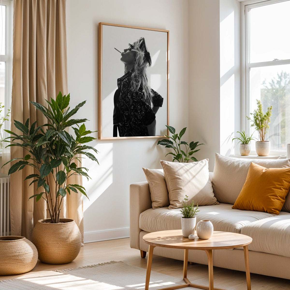 Backlit model in leather cap and sequin jacket print in an oak frame above a cream sofa beside woven planters