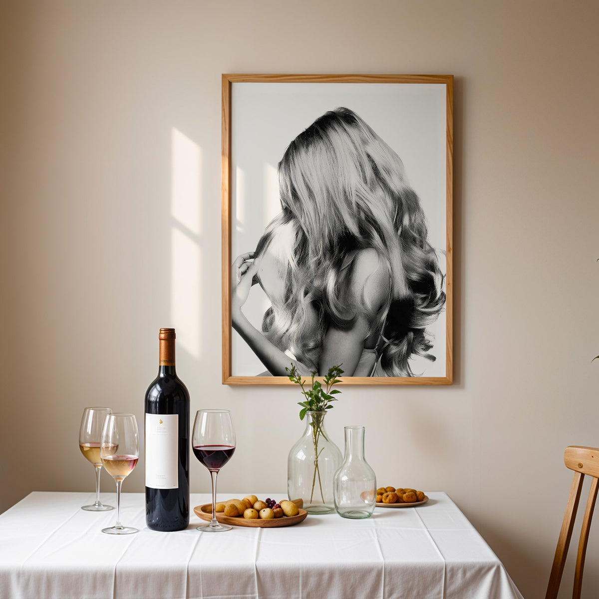 Long blonde wavy hair seen from behind print in an oak frame above a table set with red wine and glasses