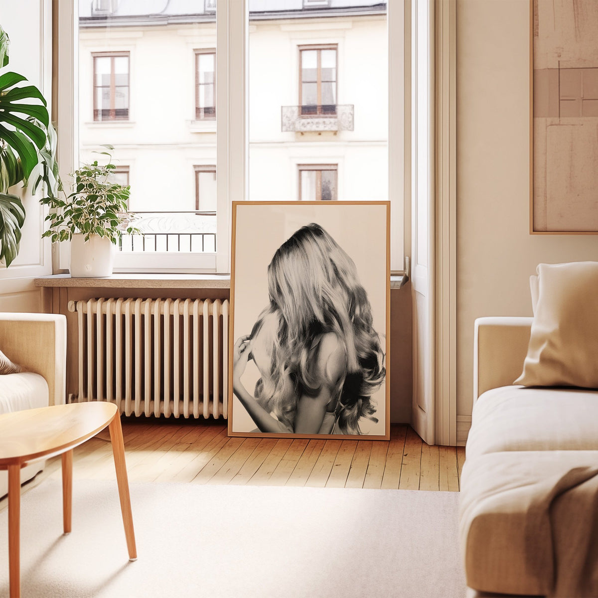 Long blonde wavy hair seen from behind print in an oak frame leaning by a French window in a living room