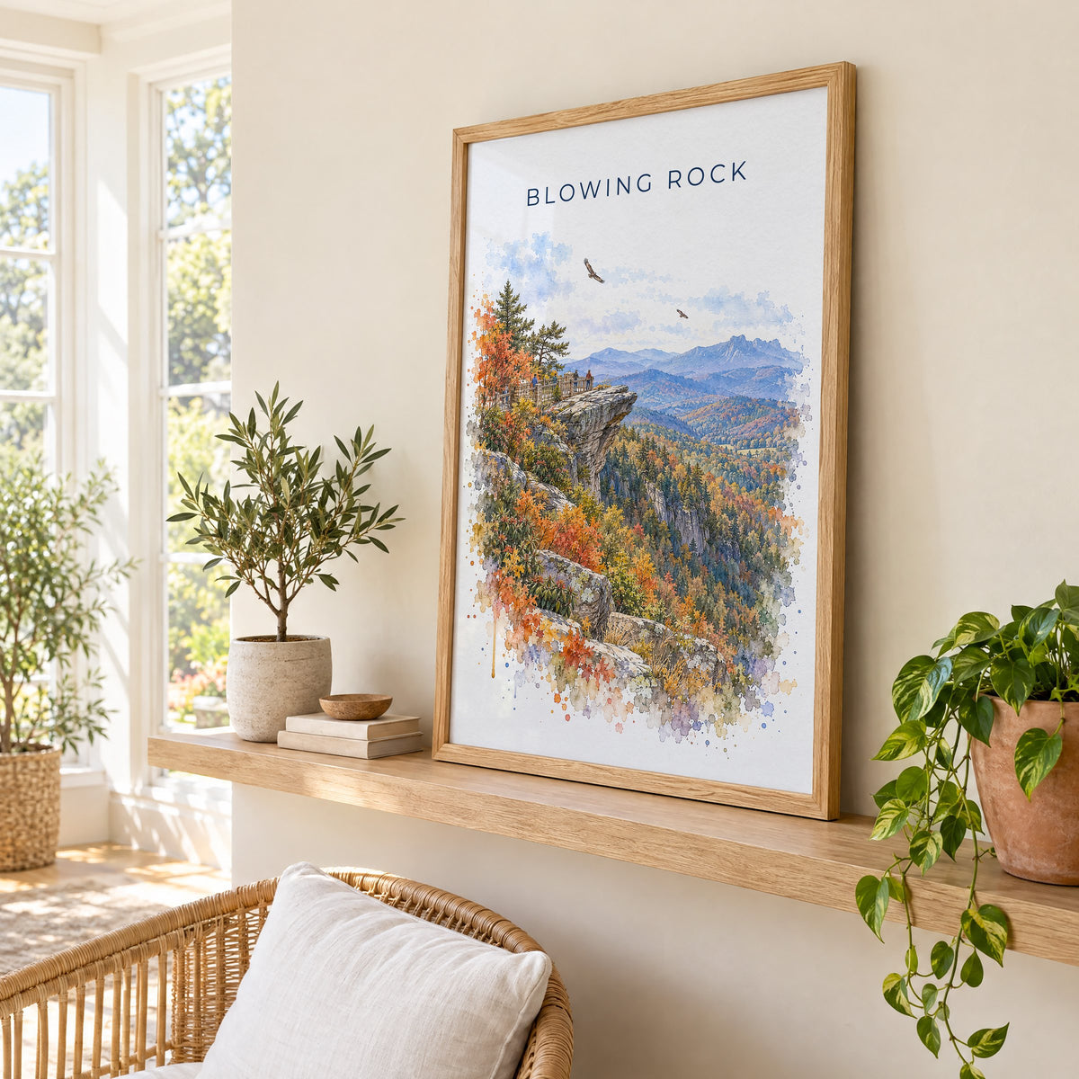 Blowing Rock watercolor print in an oak frame on a picture ledge in a sunlit sunroom