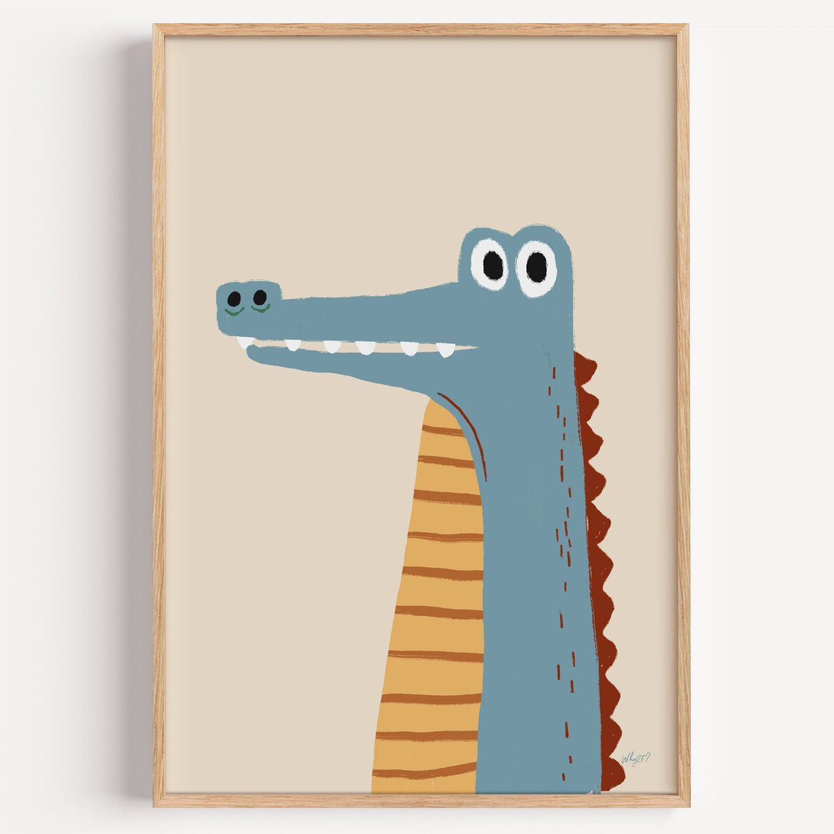 Upright blue crocodile on cream nursery print in a light oak frame on a plain white wall