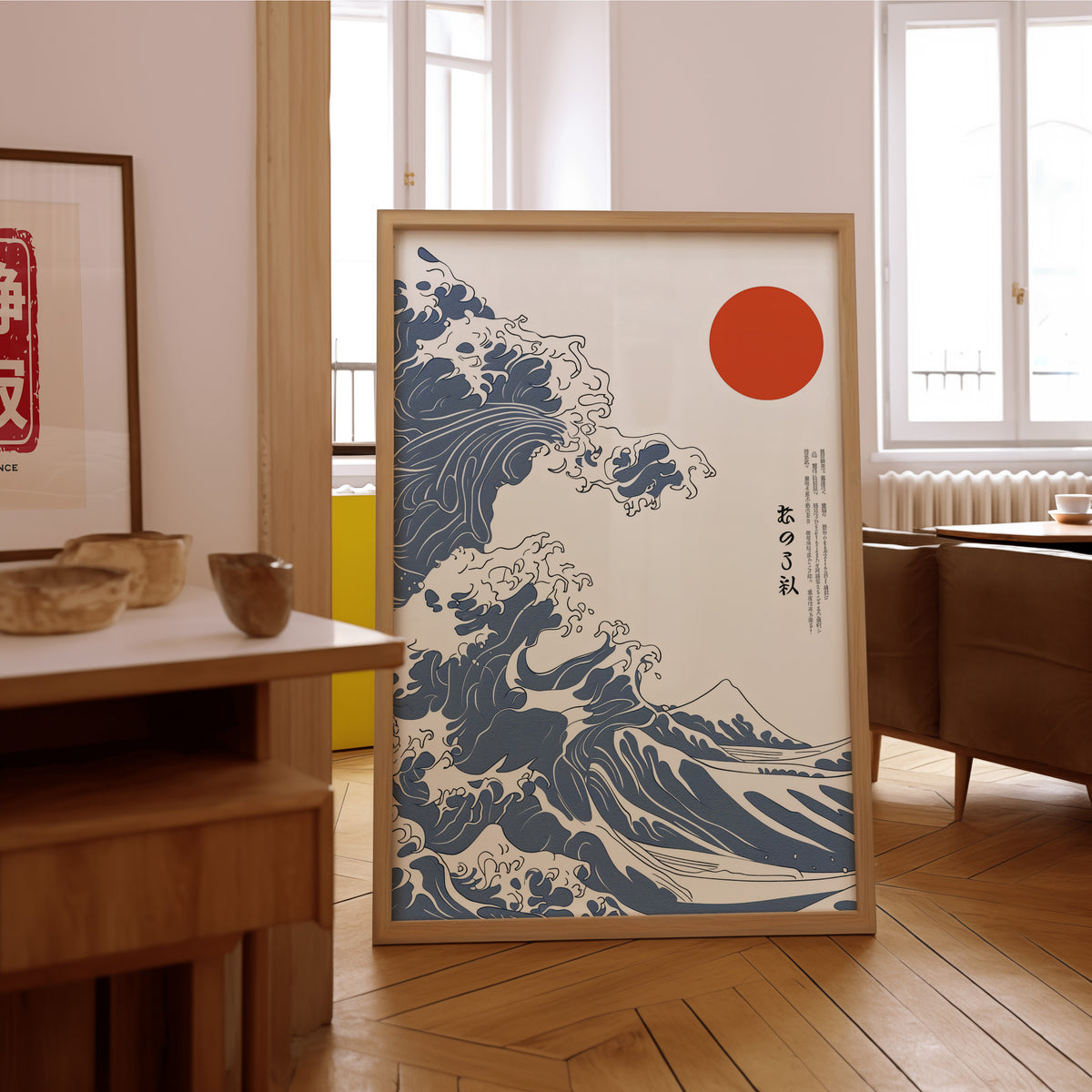 Blue Great Wave with red sun print in an oak frame on the parquet floor of a sunlit living room