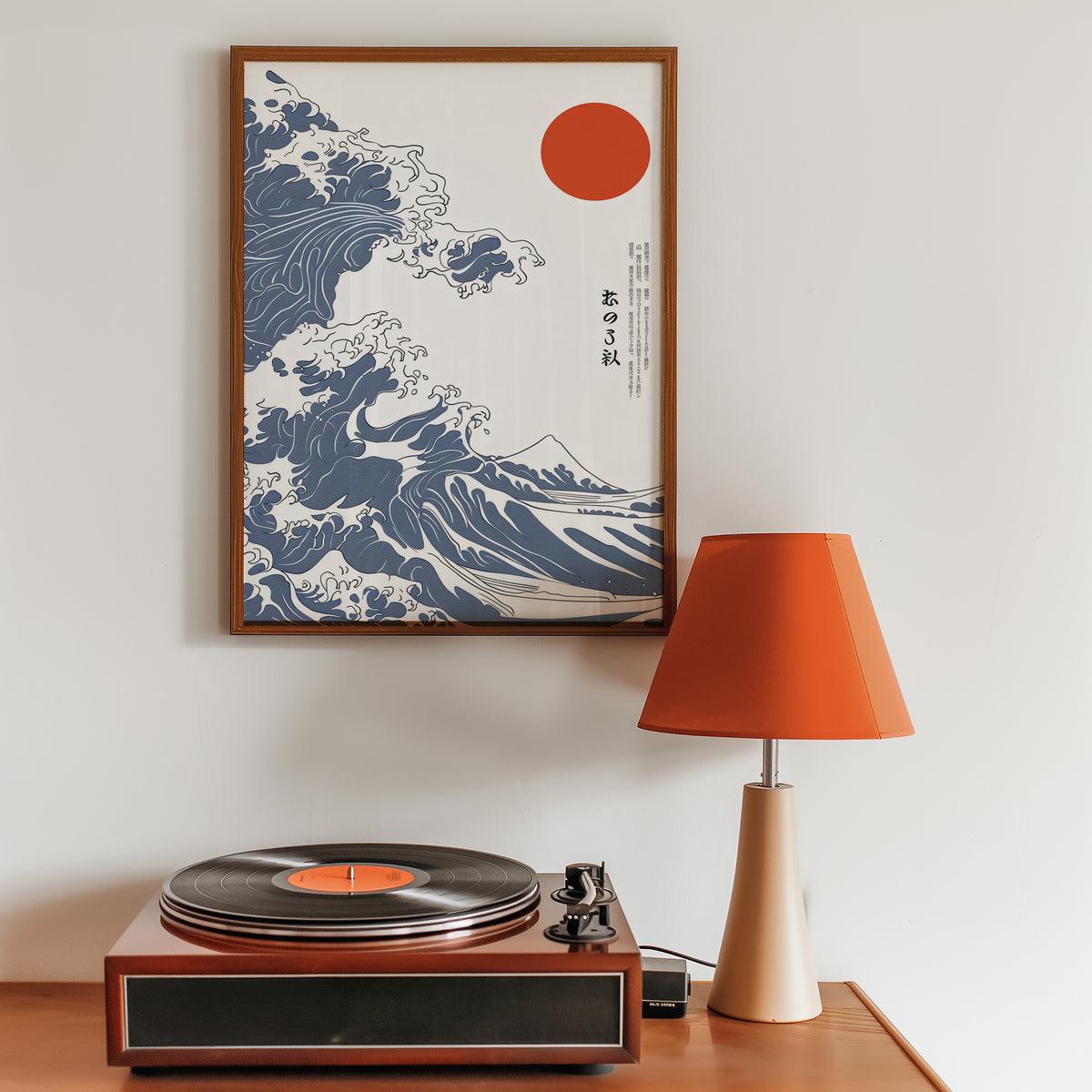 Blue Great Wave with red sun print in a walnut frame above a sideboard with a record player