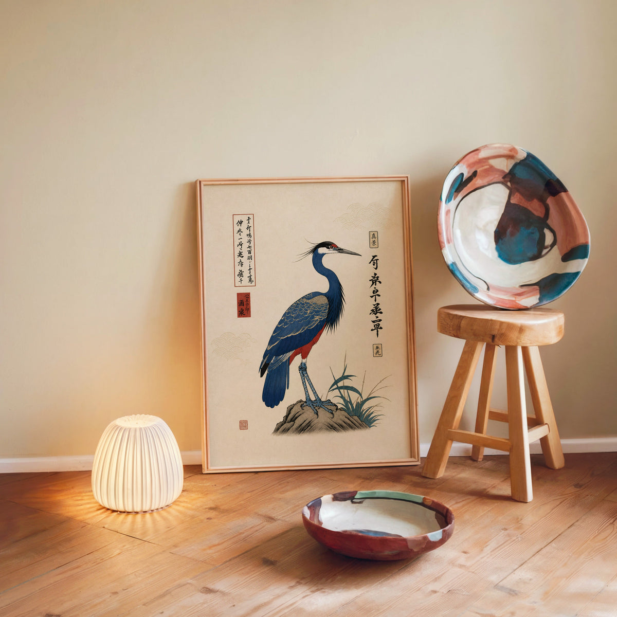 Blue crested bird on rock poster in a light wood frame leaning on a wooden floor by a glowing lamp and stool