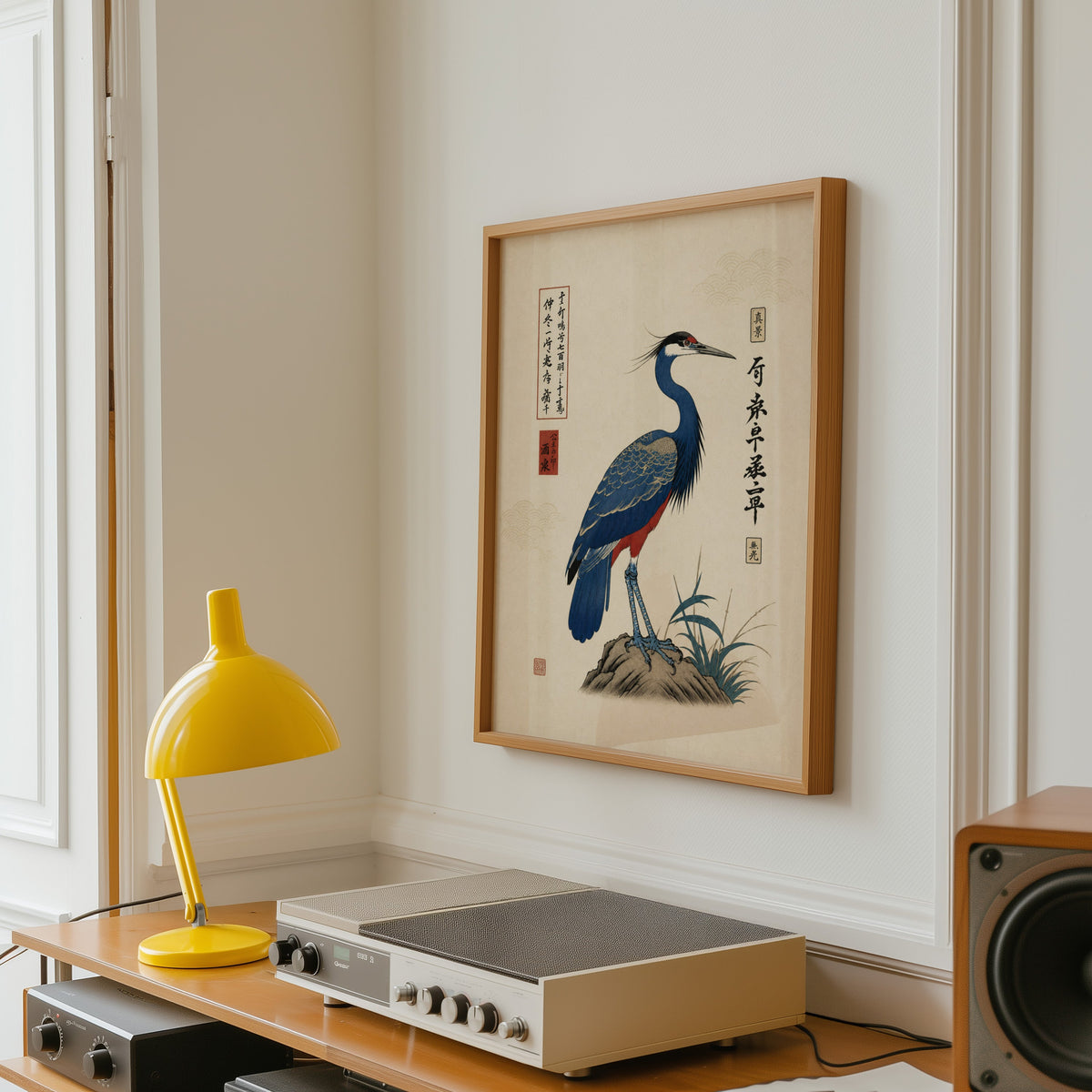 Blue crested bird on rock poster in an oak frame above a vintage hi-fi shelf with a yellow desk lamp