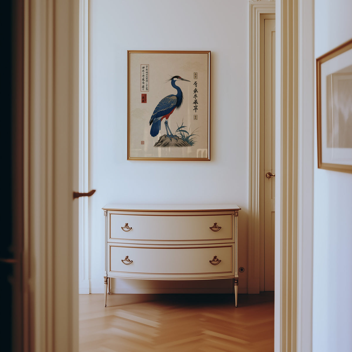 Blue crested bird on rock poster shown in a gold frame in a hallway above a cream dresser